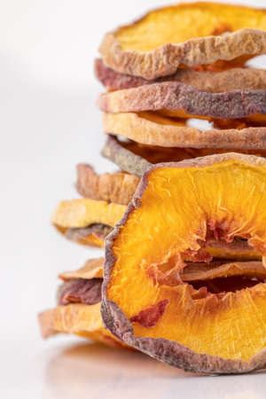 slices of dried peach on a white background. dried fruits. eco. macro. delicacy.