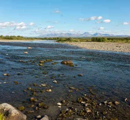 Summer river landscape with cloudy sky.の写真素材