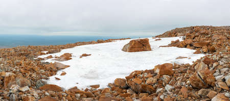 A stone plateau with non-melting snow, even in summer. Climb before the main peak of the Polar Urals.の写真素材