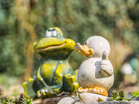 white ceramic duck and frog on the backgroundの写真素材