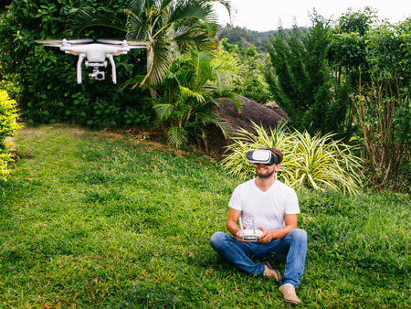 Man controls a quadrocopterの写真素材