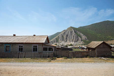 Ancient wooden settlement at the foot of mountain. Ancient village, monument of the timesの写真素材