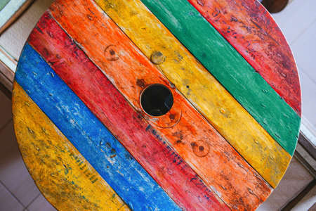 Round table made of colorful painted old timbers. Top viewの写真素材