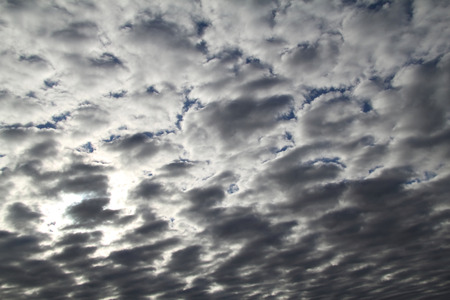 Thick clouds are illuminated by the sun in the early morning in Julyの写真素材