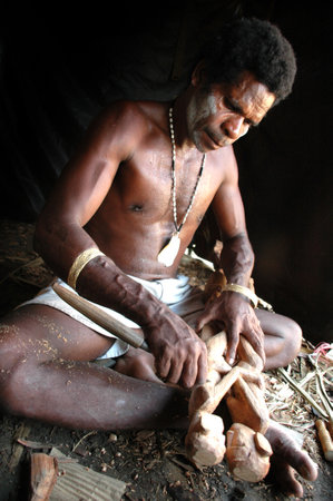 Wood sculptor from Asmat Tribe, Papua, Indonesiaのeditorial素材