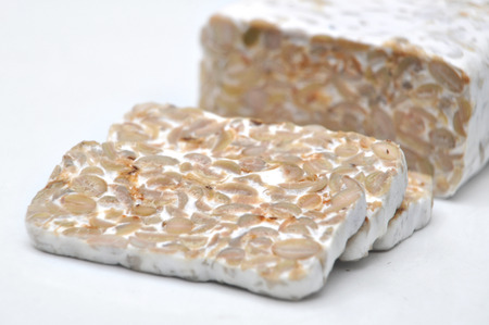 Tempe/tempeh is a traditional soy product originally from Indonesia. It is made by a natural culturing and controlled fermentation process that binds soybeans into a cake form.の写真素材