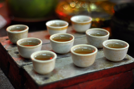 The containers filled with oil as supplies of worship in the temple Jin De Yuan, Jakarta.の写真素材