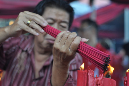 Jakarta, Indonesia - February 19, 2015: People with burner incense in hand pray at Jin De Yuan temple, Jakarta - Indonesiaのeditorial素材
