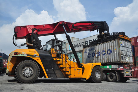 Jakarta, Indonesia - May 6, 2017: Container unloading truck in logistics yard at the port of Tanjung...
