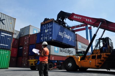 Jakarta, Indonesia - May 6, 2017: Container unloading truck in logistics yard at the port of Tanjung...