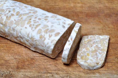 Slice of tempeh on wooden table