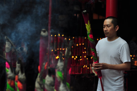 Jakarta, Indonesia - January 29, 2017: Chinese people with big incense pray to the gods in Chinese Lunar new year celebration at Jin De Yuan temple, Jakarta, Indonesiaのeditorial素材