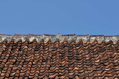 Traditional tile roof in a village in Indonesia with blue sky