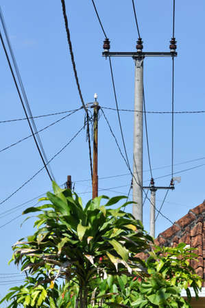 Electric cables and poles in residential areas of West Java, Indonesiaの写真素材