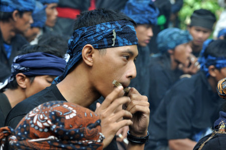 Bandung, Indonesia - June 22, 2014: Sundanese musician playing Karinding music at Sundanese traditional ceremony, Bandung - Indonesiaのeditorial素材