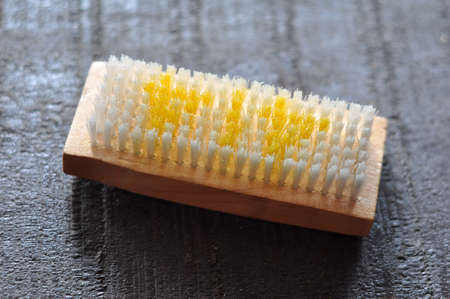 Synthetic brush with wooden handle on the floorの写真素材