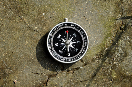 Navigation compass in asphalt ground outdoorの写真素材