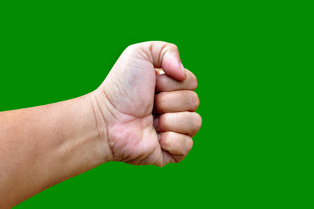 Left hand clenched hitting with green screen backgroundの写真素材