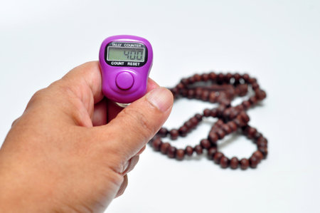 Tally digital counter in the finger white background selective focusの写真素材