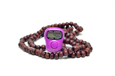 Tally digital counter in the finger white background selective focus