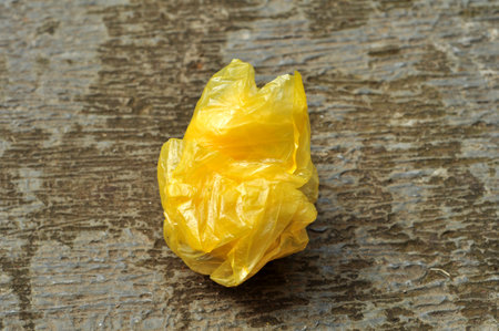 Yellow plastic bag waste pollutes the environmentの写真素材