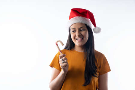 Portrait of a happy young girl wearing Santa hat isolate on a white background. Happy New Year and...