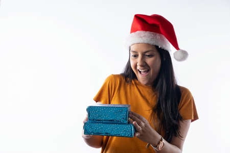 Portrait of a happy young girl wearing Santa hat isolate on a white background. Happy New Year and Merry Christmas!の写真素材