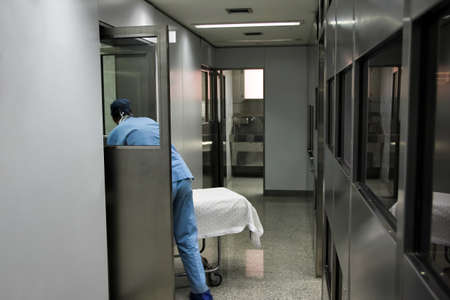 Nurse carrying hospital gurney to emergency room
