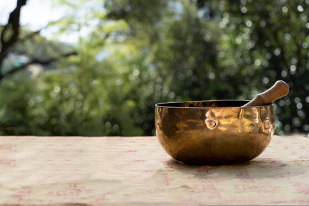 Tibetan bronze bowl on nature background. Concept meditation