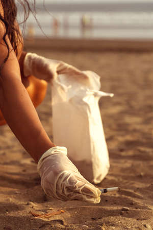 Close-up of a cigarette butt on the beach. Beach cleaning.の写真素材