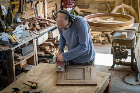 Carpenter working on wood craft at workshop to produce construction material or wooden furniture....