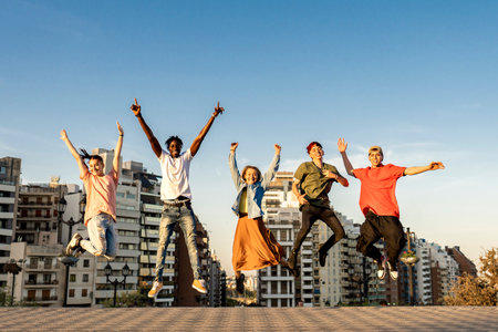 Group of diverse young people enjoying free time in the park. Main focus on blonde girl.