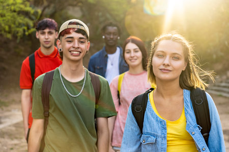 Group of diverse young people enjoying free time in the park. Main focus on blonde girl.の写真素材