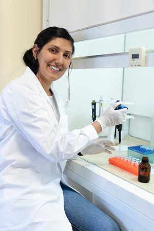 Scientist working in a fume cupboard in laboratory research.