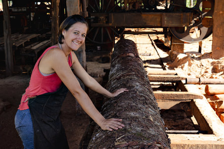 Despite the challenges of the job, a woman working in a sawmill can find fulfillment in knowing that she is contributing to the production of essential building materials.の写真素材