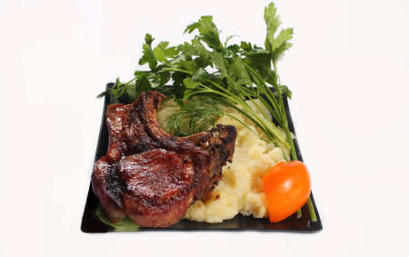 fried on the grill piece of meat with garnishの写真素材