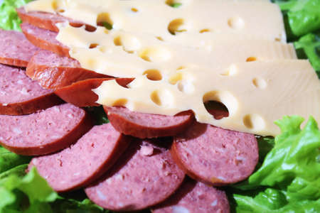 cut sausage with cheese and greensの写真素材