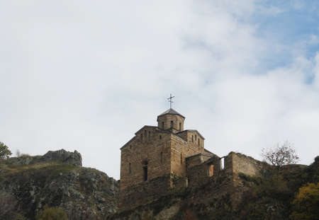 Orthodox Church against the sky in the mountains