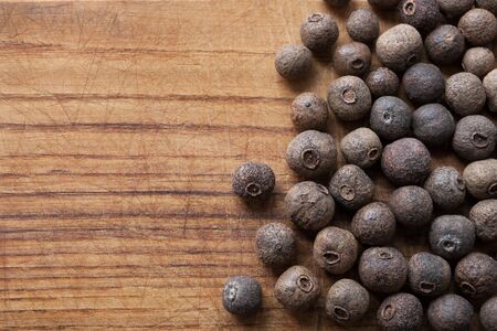 allspice berries on wooden table pepper