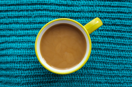 cup of coffee on a scarf in the autumnの写真素材