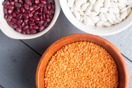 three bowls with red and white beans, lentilsの写真素材