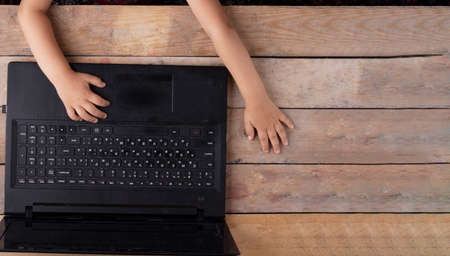 Laptop and girls hands, top view. Watching onlineの写真素材