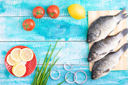 three carps on kitchen board and lemonの写真素材