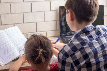 kids reading books, watching laptop
