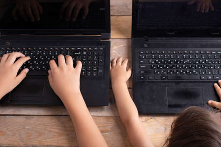 boys and girls watching online cartoons, top viewの写真素材