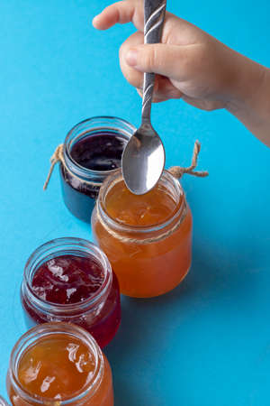 small jars with homemade jam, kids hands