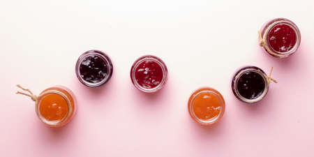 A glass of mixed berry jam with strawberries, bilberries, red currants, raspberries and blackberries, top viewの写真素材