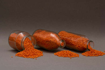 red lentils in glass bottles sprinkled on the table, copy space food