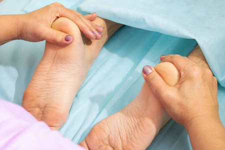Close-up of female hands doing foot massage.feet relaxing thai therapyの写真素材