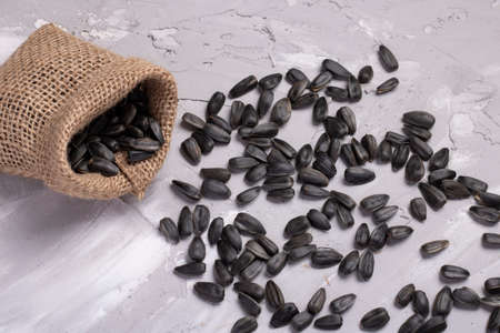 Burlap bag and heap of sunflower seeds. Zero concept, eco sackcloth